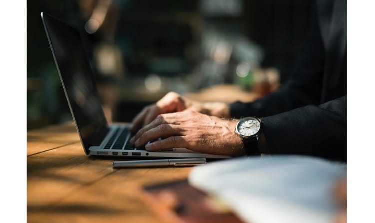 laptop with male hands typing